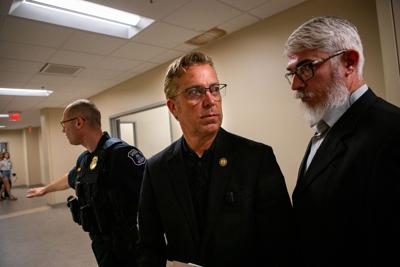 U.S. Rep. Andy Ogles is flanked by security following a student town hall at Belmont University, April 27, 2026