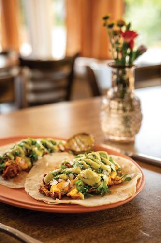 A pair of breakfast tacos from Tantísimo on a plate