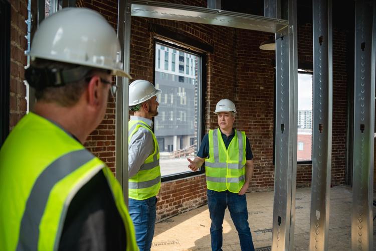 Ray Waters, Brent Hyams and Zach Liff review progress in a new green room for artists at Cannery Hall.jpg