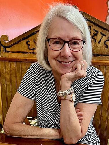 Riley Corcoran Hedrick seated in a restaurant booth