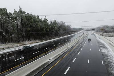 Vehicles drive on an icy I-24, January 2026