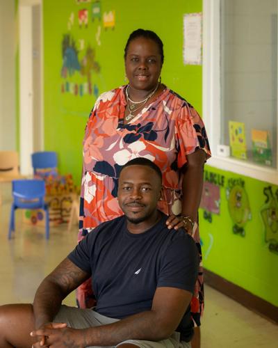 Flarrie Mahamed stands, while her son Amir Mahamed is seated