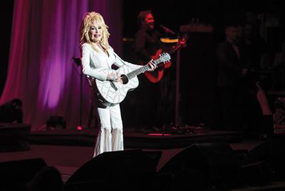 Dolly Parton sings on stage, playing a guitar. The Metro Nashville Airport Authority will rename the airport in honor of Dolly Parton, the Nashville Scene’s 2026 Best Best Bipartisan Effort in Nashville.
