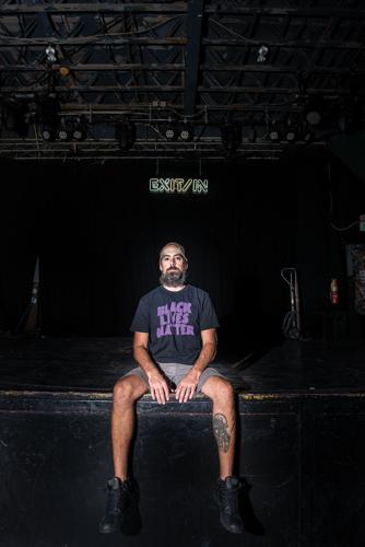 Chris Cobb, sitting on the stage of the Exit/In in 2020