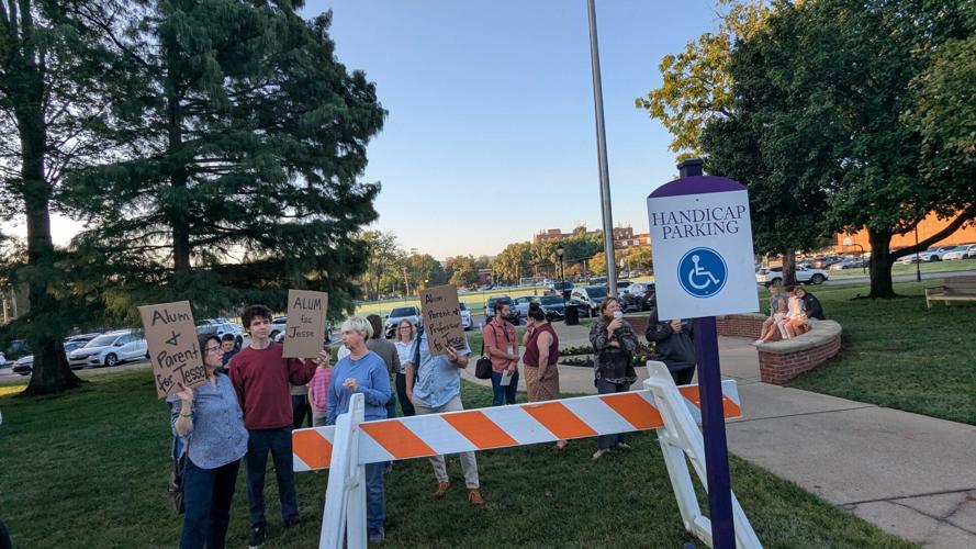 Protesters wave signs outside of Lipscomb Academy