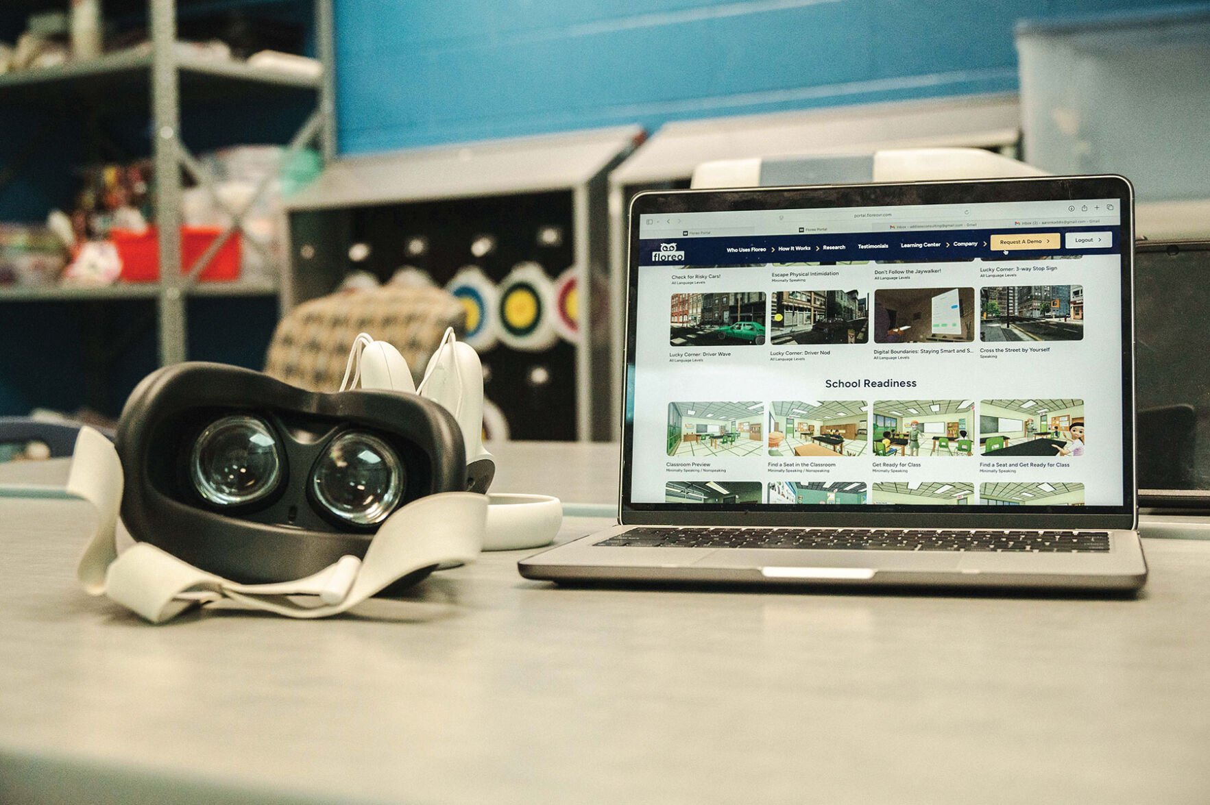 A pair of virtual reality goggles next to a laptop displaying Floreo's dashboard