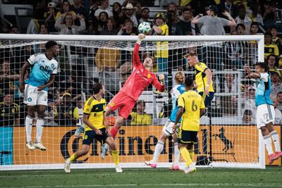 Nashville SC goalie diving for a goal shot