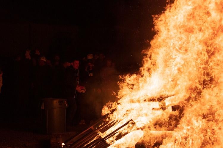 pastor carrying books to the fire.jpg