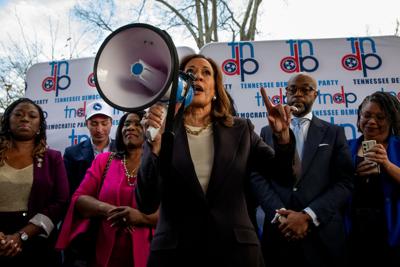 Kamala Harris holds a bullhorn, speaking in Nashville's Hadley Park