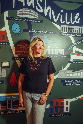 Marcie Allen Van Mol standing in front of a mural
