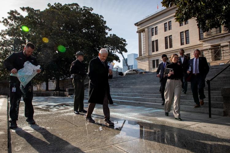 State Sen. Ken Yager walks carefully past the state Capitol