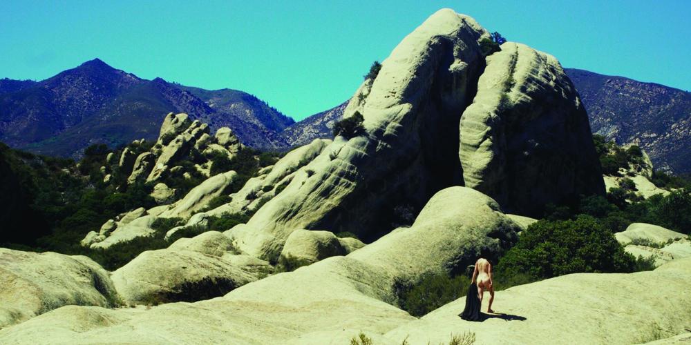 A naked figure explores a landscape in a still from “lady puritan”