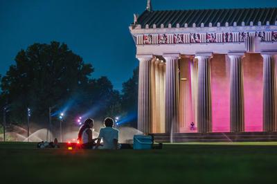 A couple sitting side by side on the lawn at Centennial Park, the Nashville Scene’s 2026 Best Cheap Date in Nashville