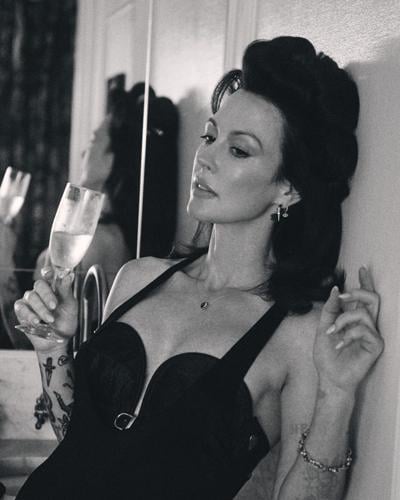 Amanda Shires 2025 press image black and white photo of artist sipping champagne