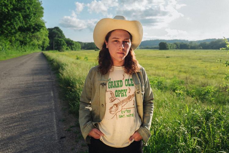 Daniel Donato press photo 2025 artist standing on the edge of a field by a road