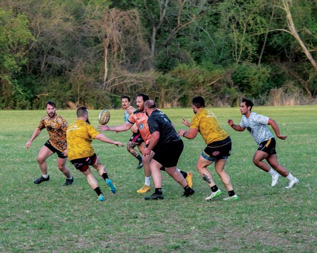 Photo of Nashville Rugby Football Club players passing the ball during a game