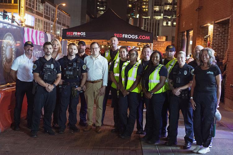 Red Frogs volunteers with MNPD officers and Nashville's night mayor, September 2024