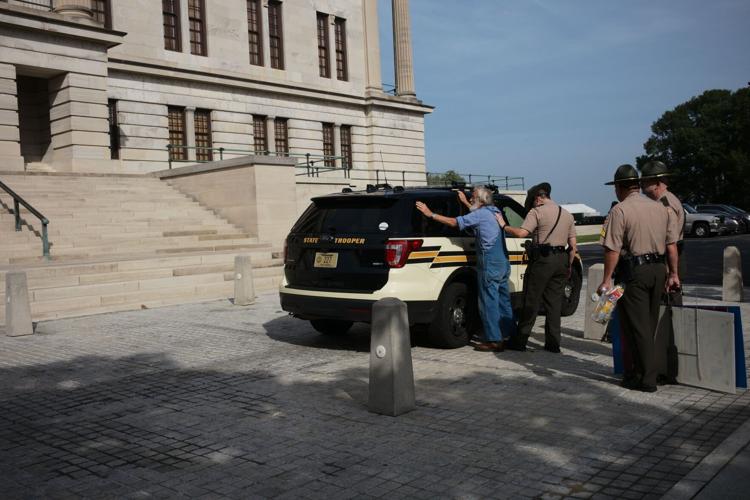Karl Meyer escorted away by state troopers