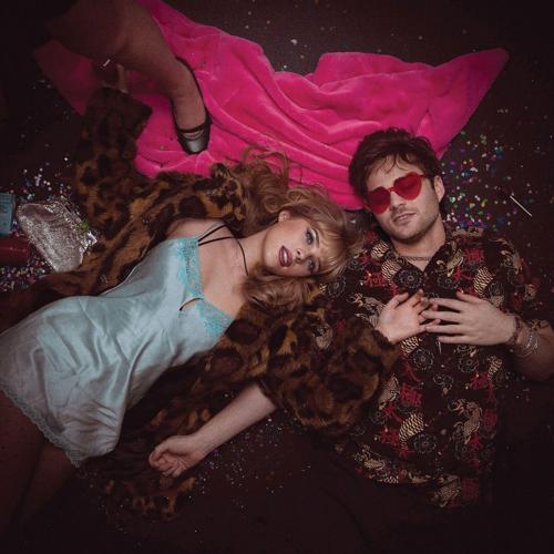 Cherry Vance artist photo band lays amid glitter on a pink towel on the floor