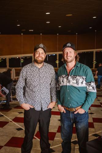 Nashville Steel Guitar Social Club co-founders Neil Jones and Mike Drassler pose at a recent meeting of the club. They both wear hats and fun shirts.