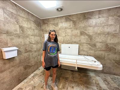 Chrissy Hood’s daughter Alaina with an adult-size changing table