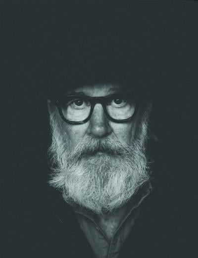 Black and white press photo of Lambchop’s Kurt Wagner, a close bust shot emphasizing his large white beard
