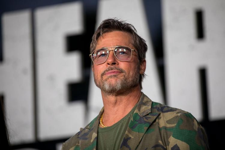 Color photograph of Brad Pitt, star of 'Heart of the Beast' — wearing fatigues and aviator sunglasses — at a premiere event for the film at FirstBank Amphitheater in Thompson's Station, Tenn., on 9/16/2026