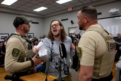A protester during public comment at a Wilson County Commission meeting, Feb. 17, 2026