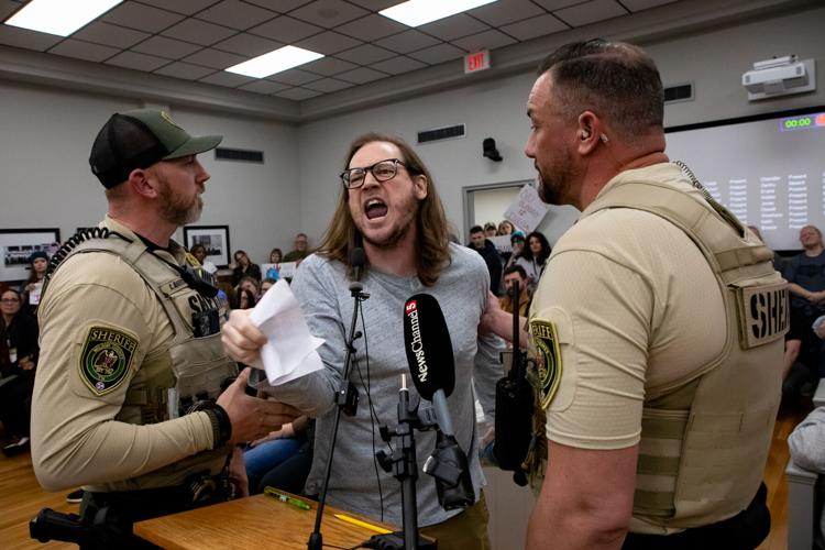 A protester during public comment at a Wilson County Commission meeting, Feb. 17, 2026