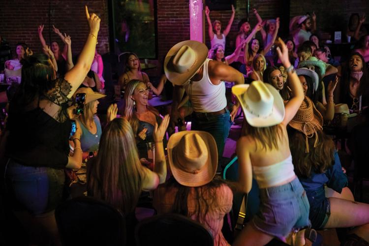 Ranch Hands performing surrounded by a group of women