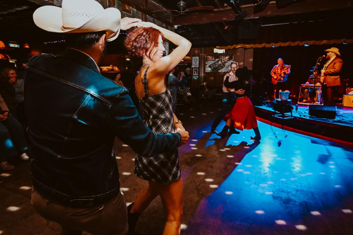 Couples partner dancing to a live country band at Skinny Dennis in Nashville