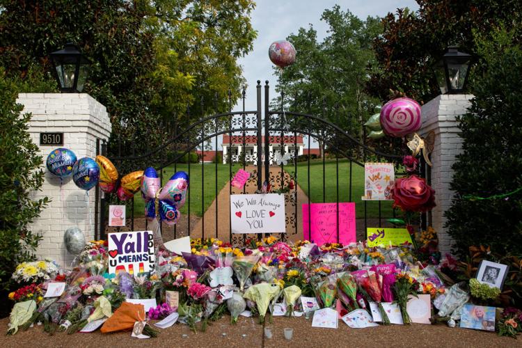 Dolly Parton fans mourn her passing, adding flowers and other mementos to a growing memorial at the gates of her Brentwood home the day after her death, Aug. 26, 2026
