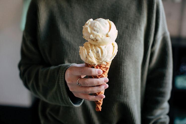 A hand holding an ice cream cone from Hattie Jane’s Creamery