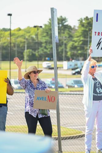 Protester holds a sign reading "AvelNo"