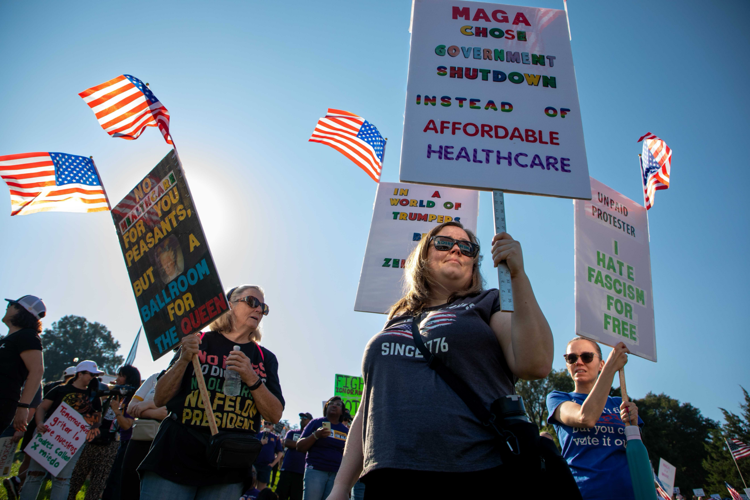 A protester hold a sign reading "MAGA chose government shutdown instead of affordable healthcare"