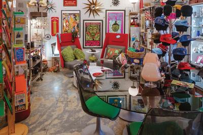 An eclectic arrangement of posters and hats and a glass table at Starland Vintage & Unusual, which is the Nashville Scene’s 2026 Writers’ Choice for Best Whimsy in Nashville.