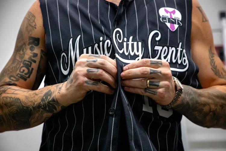 Music City Gents performer buttoning his shirt