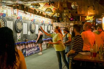 A person throwing darts at Villager Tavern, the Nashville Scene’s 2026 Best Place to Throw Darts in Nashville