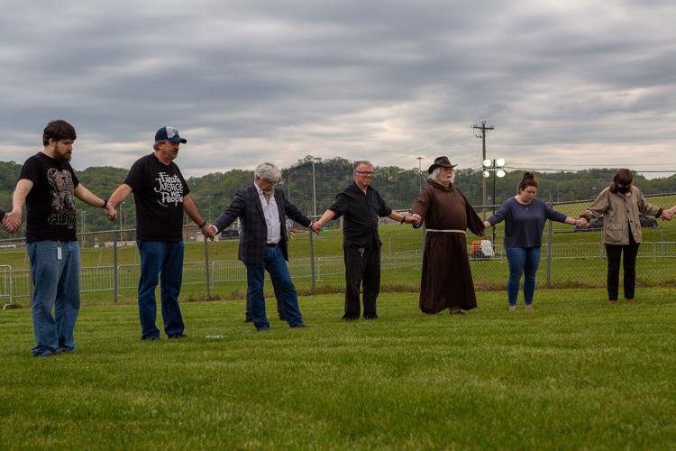 Anti-death-penalty protesters pray outside Riverbend on April 21