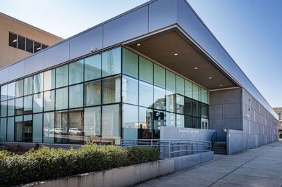 The corner of a blocky cement and glass structure