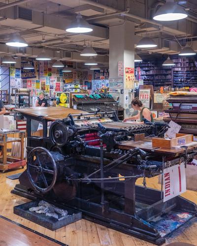 countless posters surrounding a printing press at Hatch Show Print, the Nashville Scene’s 2026 Best Printmaker/Poster Designer in Nashville