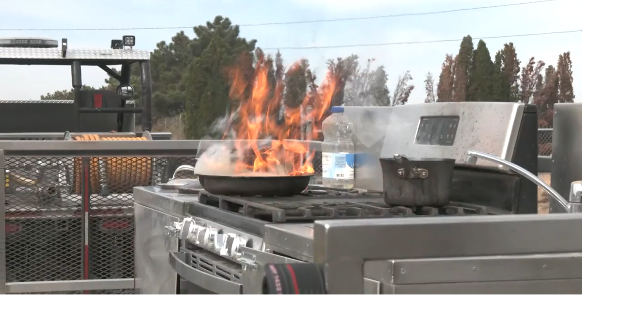 Pasco Fire Department's Ben Shearer demonstrates how to stop a cooking