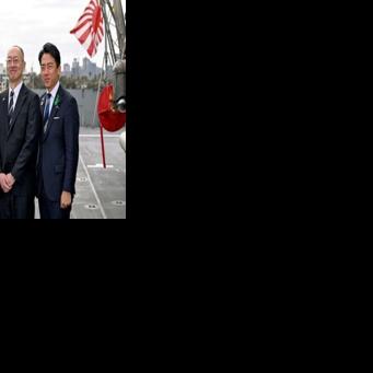 (FILES) Australia's Deputy Prime Minister and Minister for Defence Richard Marles (L) and Japan's Minister of Defense Koizumi Shinjiro (R) pose for a photo with Eisaku Ito, President and CEO of Mitsubishi Heavy Industries, before the signing of the…
