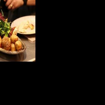 A cook prepares a rotisserie chicken with potatoes during dinner in the French restaurant Gigi’s in the Brooklyn borough of New York City on April 26, 2026