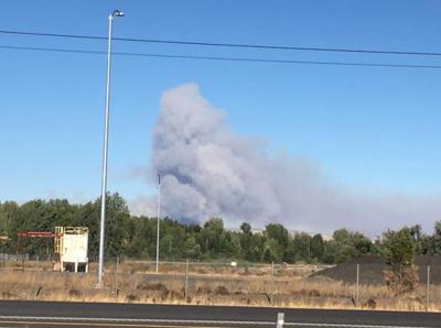 Fire crews battling a fire that started in brush and grass near the ...