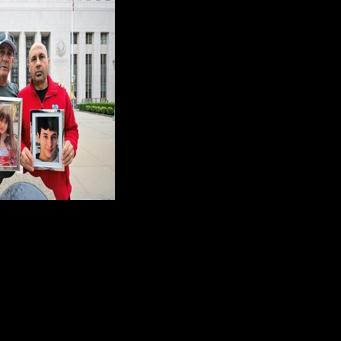 Parents Mariano Janin and George Nicolaou hold photos of their children outside the Los Angeles County Superior Court in Los Angeles