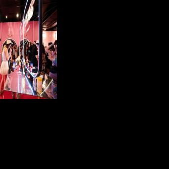 People test products inside the promotional booth of South Korean skincare brand Medicube