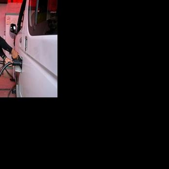 Electric microbus driver Purushottam Adhikari charges his Chinese-made e-van at a charging station in Kathmandu