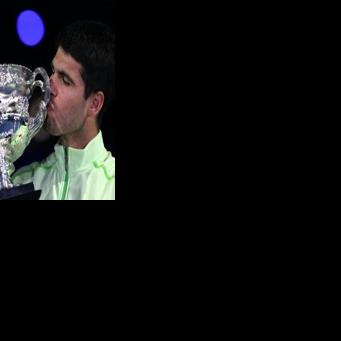 Spain’s Carlos Alcaraz celebrates with the Norman Brookes Challenge Cup