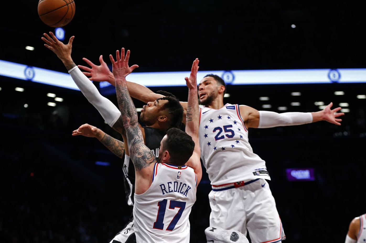 Brooklyn Nets guard D' Angelo Russell, center, shoots over Philadelphia  76ers guard Ben Simmons, during the first half game between the  Philadelphia 76ers and the Brooklyn Nets in Game 3 of their